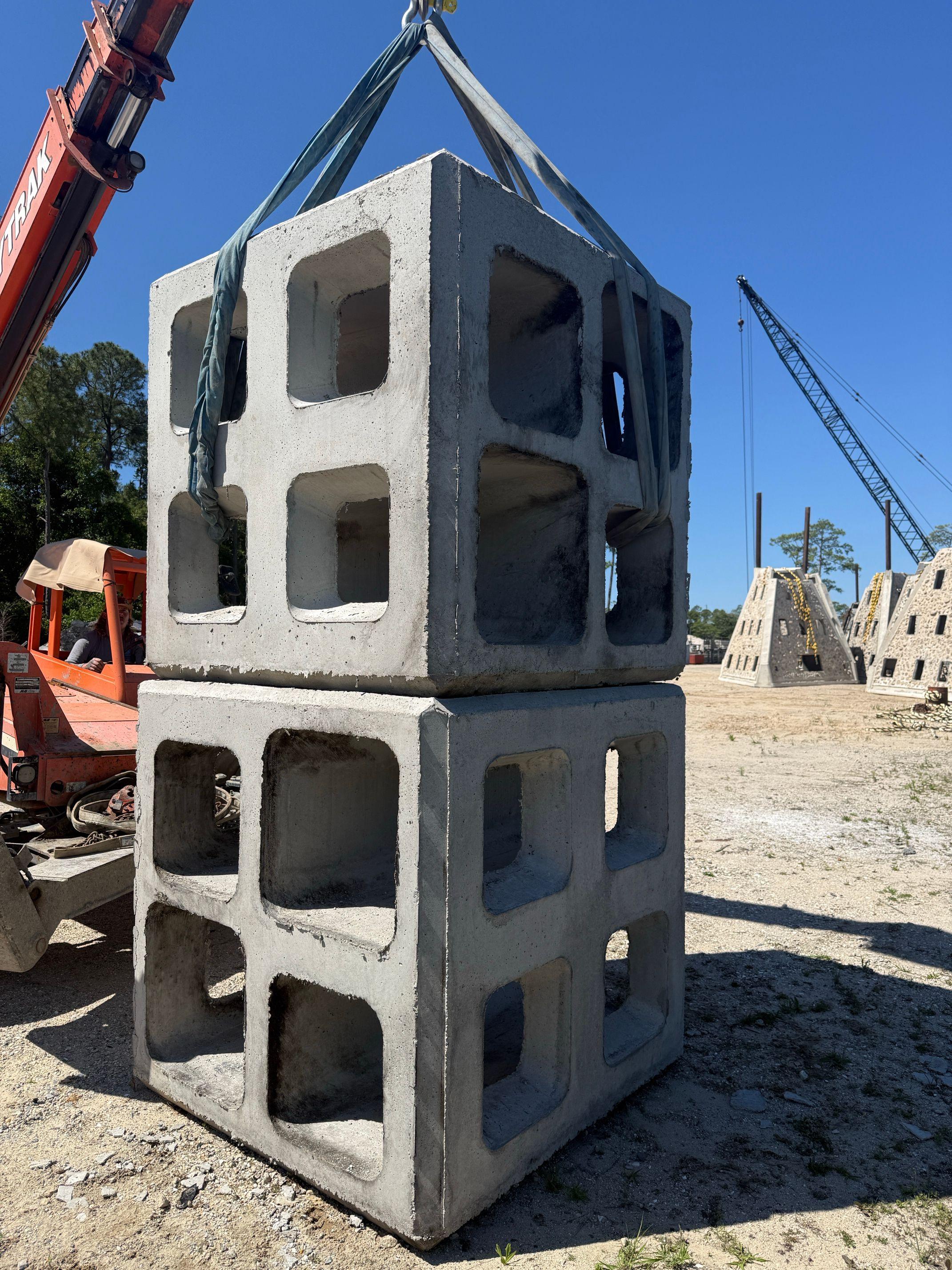 Two stacked Marine Matrix artificial reef modules suspended from lifting straps
