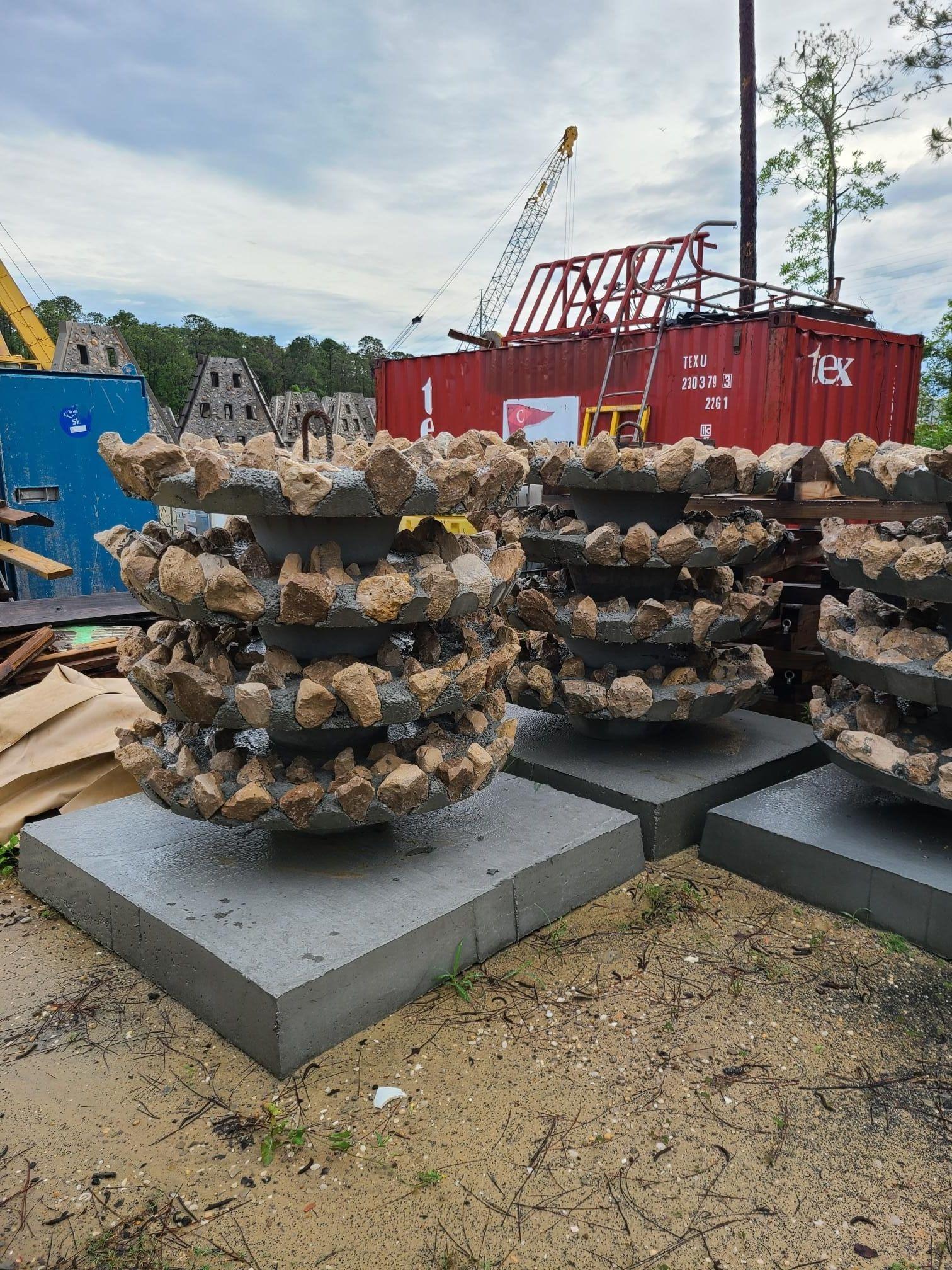 Shell-covered estuary reef modules arranged beside the water