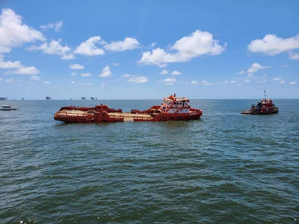 Orange vessel in process of sinking