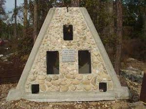 Limestone-covered pyramid reef module displayed outdoors