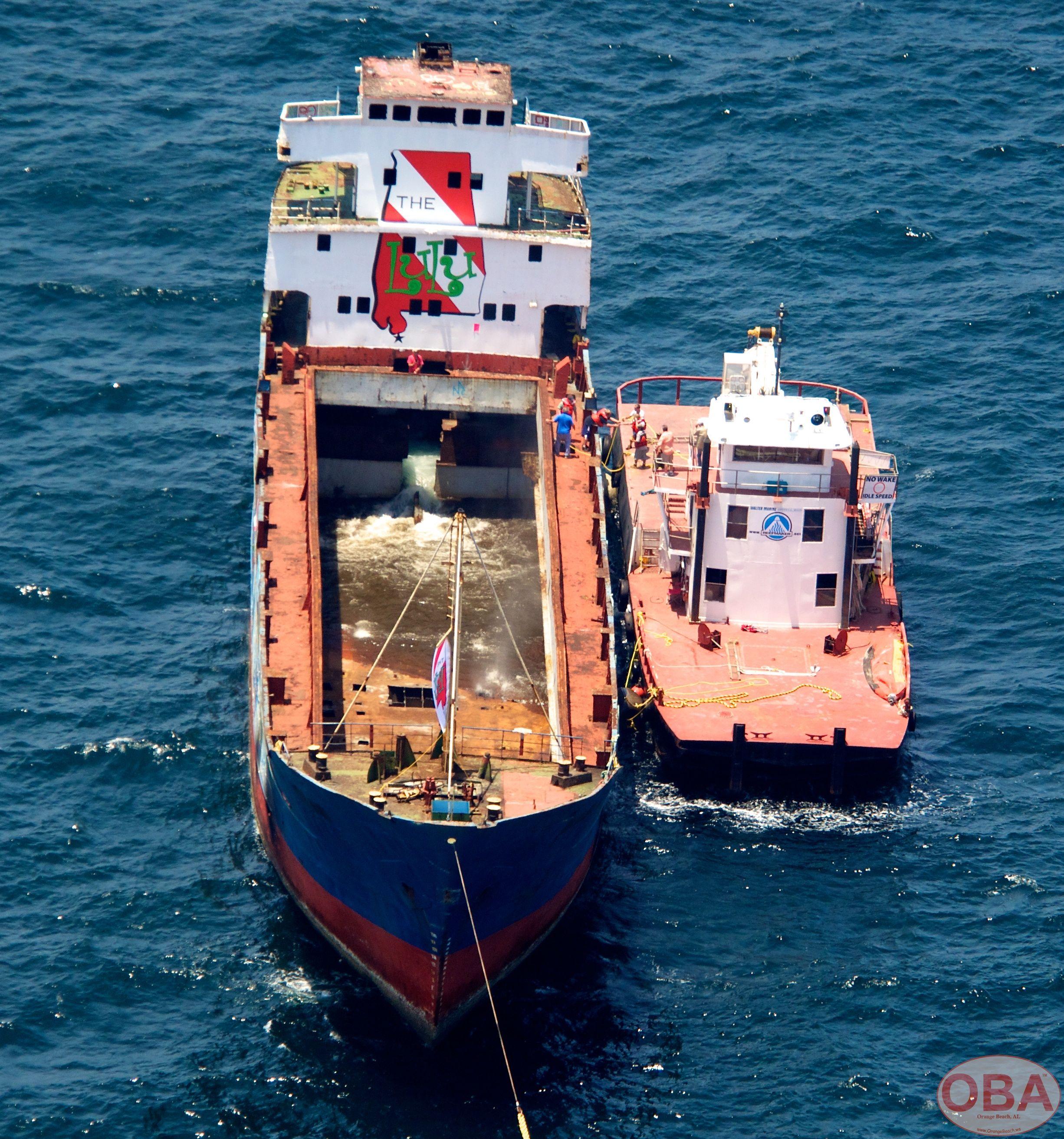 Aerial view of a tugboat assisting the LuLu during the sinking operation